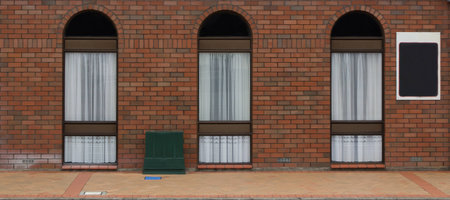 Three modern arch windows in a brick wall の写真素材