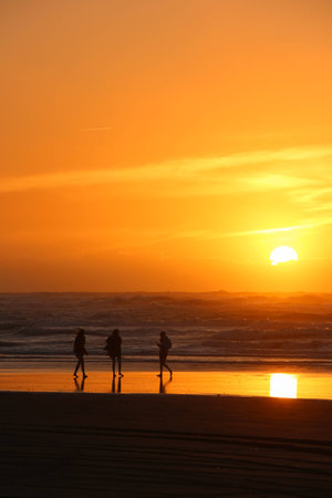 After a hot summers day the sky has a wonderful warm color as the sun goes down.の写真素材