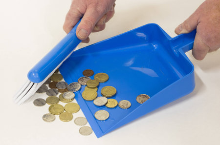 Clean up some coins with a brush an shovel.の写真素材