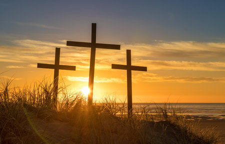 Three cross on a sand hill as the sunsets.の写真素材