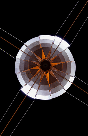 Star made of steel held up by cables.