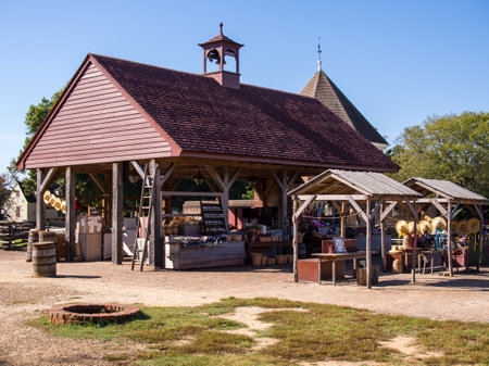 Step back in time with this stunning photograph of a Colonial Williamsburg market on a sunny day! The clear blue sky provides the perfect backdrop for the vibrant colors of the marketplace, which is filled with local produce, handcrafted goods, and friendly vendors. The historic trades and crafts on display will transport you to another era, allowing you to experience firsthand the rich history and culture of America's past. This photograph is the perfect addition to any collection, providing a glimpse into a simpler time and a celebration of the beauty and authenticity of handmade goods.の写真素材