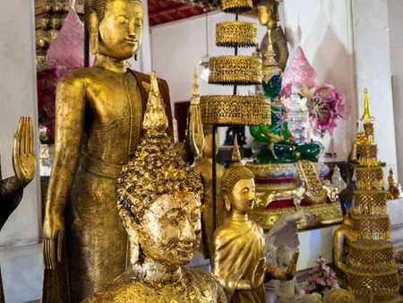 Experience the divine beauty of the golden Buddha statues, illuminating the sacred halls of the Wat Arun Temple in Bangkok, Thailand. With intricate details and striking craftsmanship, this photo captures the essence of the Buddhist culture and its reverence for the divine.の写真素材