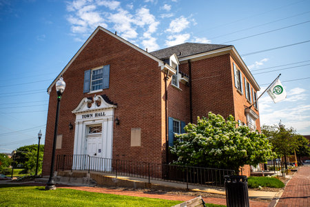 Under a serene blue sky, capture a side view of Herndon, Virginia's City Hall, epitomizing the town's charm and civic pride.の写真素材