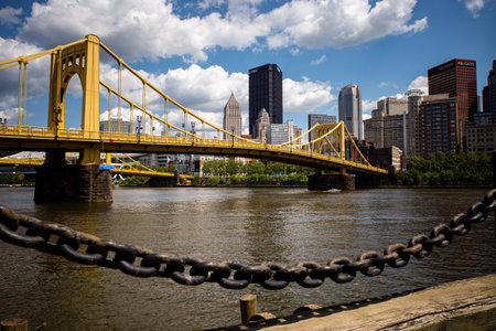 On a sunny day, the vibrant Andy Warhol Bridge stretches across the Allegheny River, with downtown Pittsburgh providing a picturesque backdrop.のeditorial素材