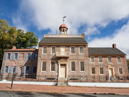 The facade of the New Castle Court House Museum, a significant colonial red brick landmark, under a...