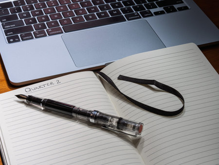 Organizing the second quarter of the year using a fountain pen and an open notebook on a...