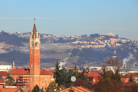 View on church in Alba and villages on surrounding hills in Piedmont, northern Italy.の写真素材