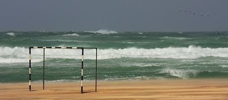 View on stormy Mediterranean Sea and football gate on the beach.の写真素材
