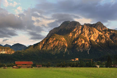 German meadows and mountains at sunset.の写真素材