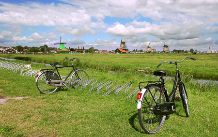 Green fields, creek and windmills in famous Zaanse Schans village near Amsterdam, Netherlands.の写真素材