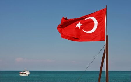 Turkish National Flag waiving on the wind on Mediterranean Sea in Kemer (Antalya), Turkey.の写真素材