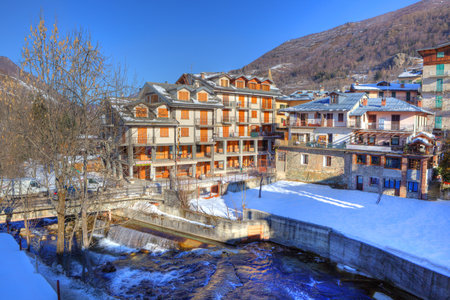 Hotel building and residential houses in snowy Limone Piemonte - popular touristic resort in northern Italy.のeditorial素材