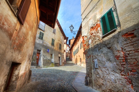 Narrow paved street among old historic houses in Saluzzo, northern Italy の写真素材