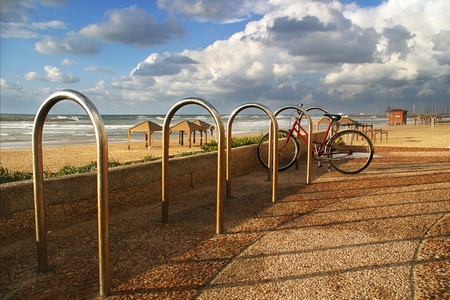 Bicycle on promenade along the shore of Mediterranean sea under the cloudy sky in Tel Aviv, Israel の写真素材