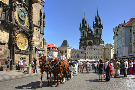 PRAGUE - JULY 17 2009 : Tourist carriage passes by Old Town Square (Stare Mesto) in front of Tyn Church and famous Astronomical Clock july 17, 2009 in Prague, Czech Republic.のeditorial素材