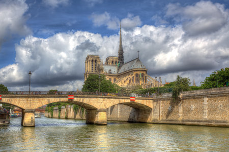View on Notre Dame Cathedral under beautiful sky with white clouds in Paris, France のeditorial素材