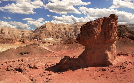 View on mushroom shaped red rock and mountains on background at Timna National Park in Arava Desert, Israel の写真素材