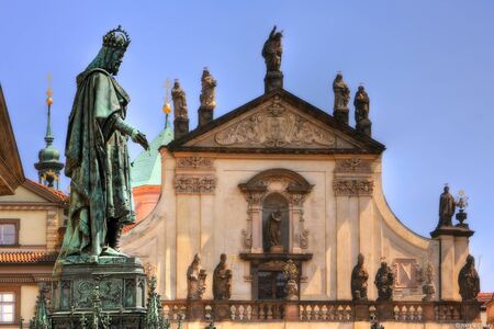 Famous statue of King Charles IV in front of old church near Charles Bridge in Prague, Czech Republic の写真素材