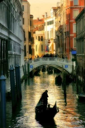 Vertical oriented image of gondola passing on small canal among historic houses in Venice, Italy の写真素材
