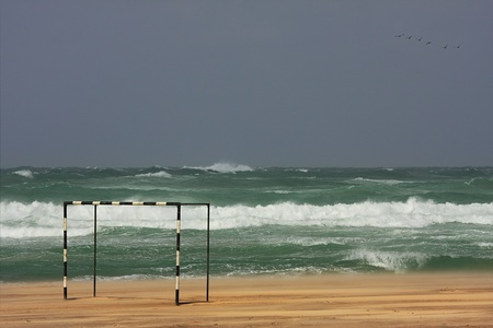 View on stormy Mediterranean Sea and football gate on the beach.の写真素材