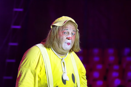 ISRAEL - JULY 03: Portrait of clown in yellow costume and traditional makeup on the face at performance on arena of Circus Europe during the tour in Israel on July 03, 2010.のeditorial素材