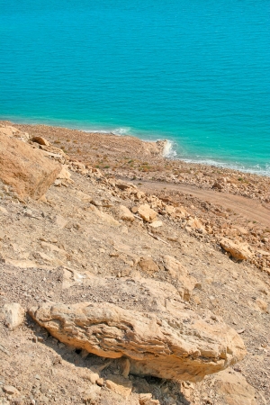 Vertical oriented image on rocky slope and deserted coast on Dead Sea in Israel の写真素材