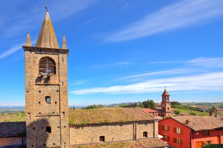 Old brick belfry tower and abandoned church under blue sky in town of Serralunga Dの写真素材