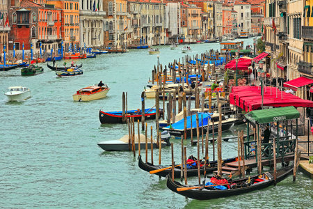 VENICE - NOVEMBER 13  View of Grand Canal, gondolas and promenade with bars and restaurants - one of the most popular places with tourists as seen from Rialto Bridge in Venice, Italy on November 13, 2012 のeditorial素材