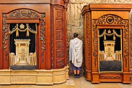 JERUSALEM - AUGUST 21  Prayer in Cave Synagogue between two wooden cabinets with Torah scrolls  Cabinets located in the cave which is a part of Western Wall - Judaism holy place in Jerusalem, Israel on August 21, 2013 のeditorial素材