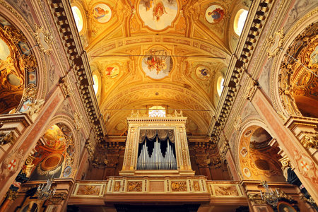 Organ and fragment of ornate ceiling as part of catholic church interior in Italy のeditorial素材