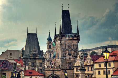 Old medieval tower and sculptures on famous Charles Bridge in Prague, Czech Republic の写真素材