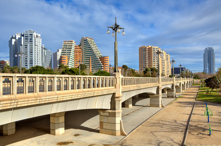 Bridge across former river bed of Turia towards contemporary hotel and residential buildings in Valencia, Spain の写真素材