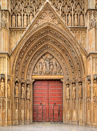 Wooden door  Apostles Gate  surrounded by small statues at the entrance to Saint Maryの写真素材