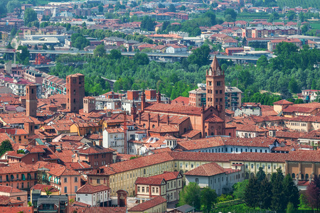 Typical italian houses with red rooftops and bell tower of the cathedral in old town of Alba, Italy  view from above  の写真素材