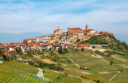 Small italian town and vineyards on the hills in early spring in Piedmont, Northern Italy の写真素材