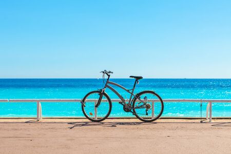 Bicycle on famous Promenade des Anglais as Mediterranean sea on background in Nice France.の写真素材