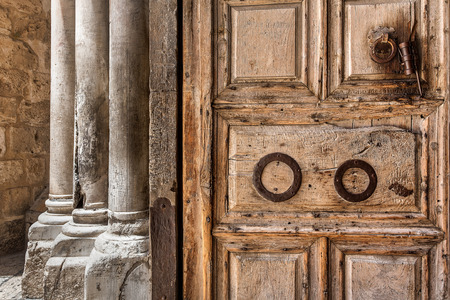 Ancient wooden door and marble pillars at the entrance to Church of the Holy Sepulchre in Jerusalem Israel.の写真素材