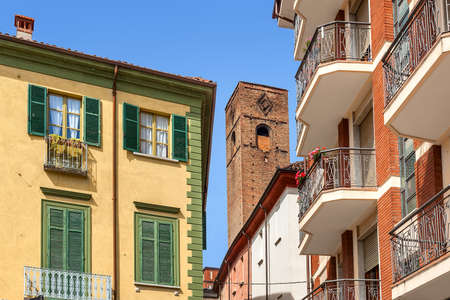 Medieval tower among typical italian houses in town of Alba in Piedmont, Northern Italy.の写真素材