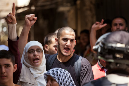 JERUSALEM, ISRAEL - JULY 26, 2015: Palestinians in Old City of Jerusalem protest against ascent of religious jews to Temple Mount during Tisha B'Av - annual fast day in Judaism commemorates destruction of  First and Second Temples.のeditorial素材