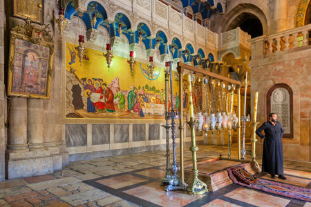JERUSALEM, ISRAEL - JULY 26, 2015:  Stone of Anointing and mosaic icon on the wall at the entrance...