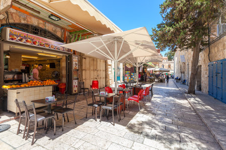 JERUSALEM, ISRAEL - JULY 10, 2014: Typical outdoor restaurant in Muristan neighborhood in Old City  - famous and popular site with tourists and pilgrims visiting Jerusalem.のeditorial素材