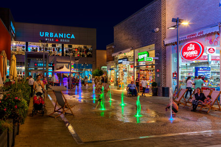 ASHDOD, ISRAEL - JULY 03, 2016: Shops, boutiques and illuminated fountains in openair mall at evening - owned by BIG Shopping Centers Ltd., founded in 1994 and operates in four countries - Israel, the United States, India and Serbia.のeditorial素材
