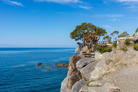 Villa on the cliff overlooking beautiful Mediterranean sea under blue sky in small town of Recco in Liguria, Italy.の写真素材