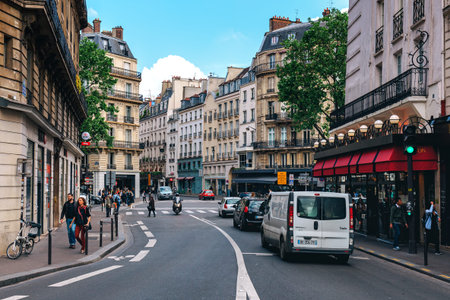 PARIS, FRANCE - MAY 25, 2016: People walking on the street among typical parisian buildings in the center of Paris - capital of France, famous and popular tourist destination.のeditorial素材
