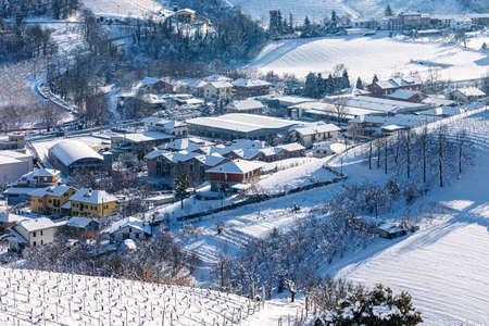 View from above on the hills and small town covered in snow in Piedmont, Northern Italy.の写真素材