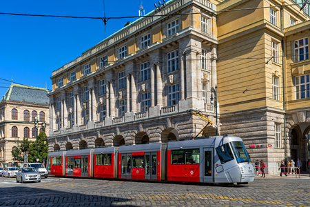 PRAGUE, CZECH REPUBLIC - SEPTEMBER 04, 2019: Modern tram on the cobblestone street in historic center of Prague - capital and largest city of Czechia, famous and popular tourist destination.のeditorial素材