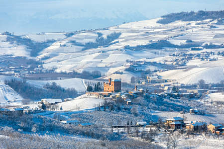 View of hills and vineyards of Langhe area covered in snow in Piedmont, Northern Italy.の写真素材