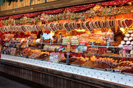 VIENNA, AUSTRIA - DECEMBER 04, 2019: Heart-shaped gingerbread cookies and other traditional sweets on sale at famous Christmas market in Vienna - capital of Austria, popular tourist destination.のeditorial素材