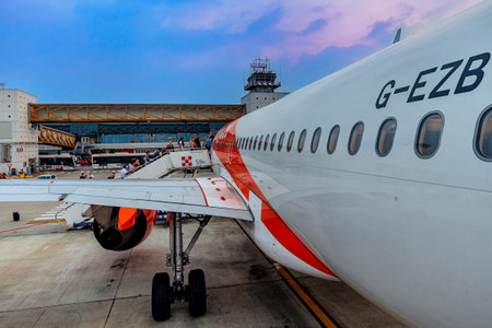 MILAN, ITALY - JULY 07, 2015: People boarding EasyJet flight at Malpensa international airport - largest international airport in Milan and 2nd busiest airport in Italy.のeditorial素材